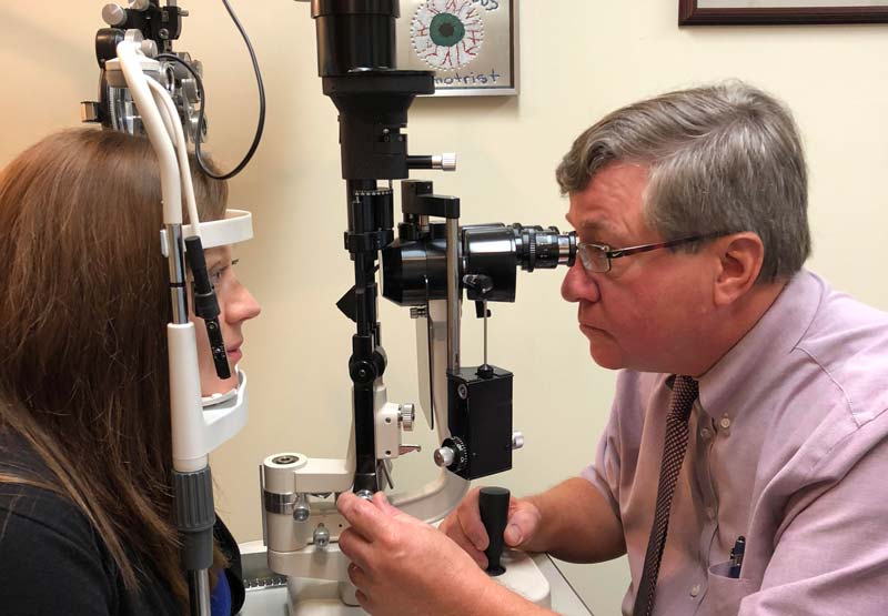 Price Optical eye doctor checking a patient's eyes